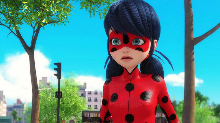 marinette standing in the street beside trees